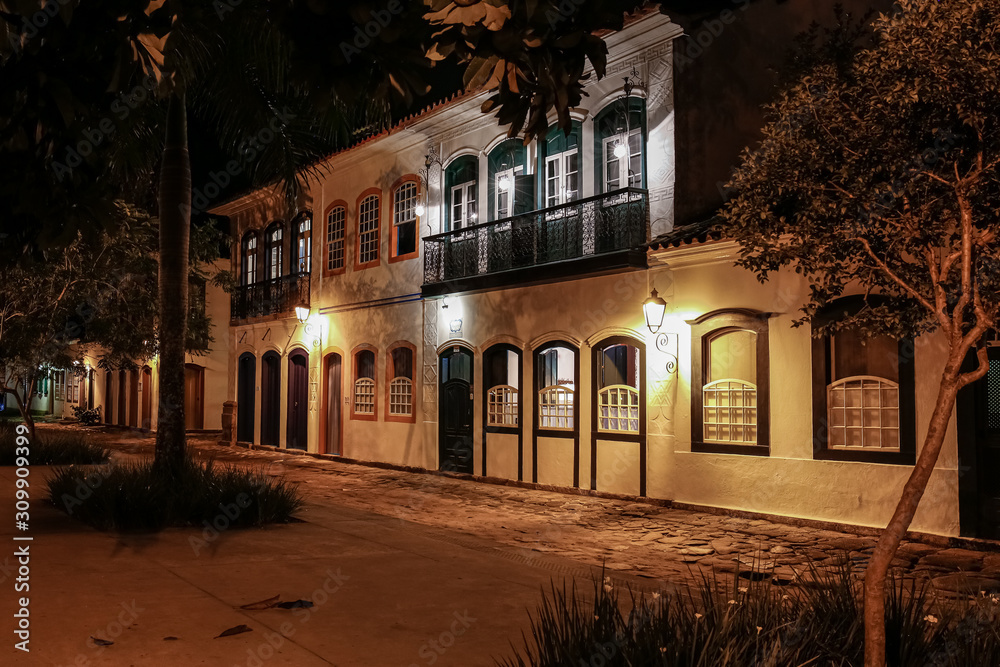 Atmospheric night view of illuminated street and buildings in historical center of Paraty, Brazil, Unesco World Heritage