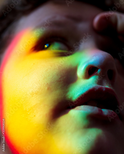 Portrait of a boy in the light of the rainbow