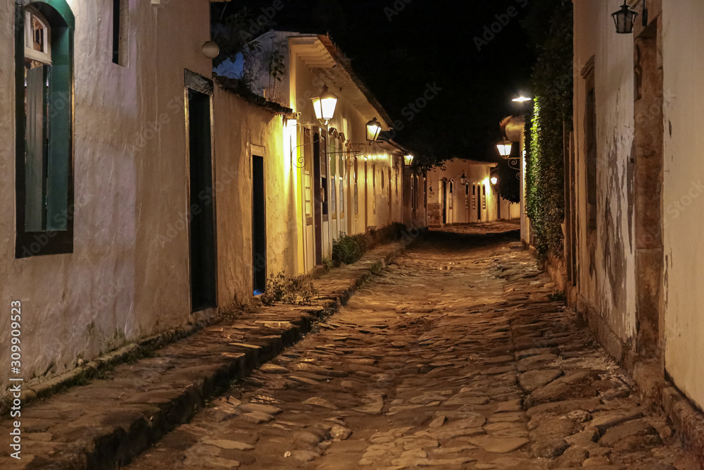 Atmospheric night view of illuminated street and buildings in historical center of Paraty, Brazil, Unesco World Heritage
