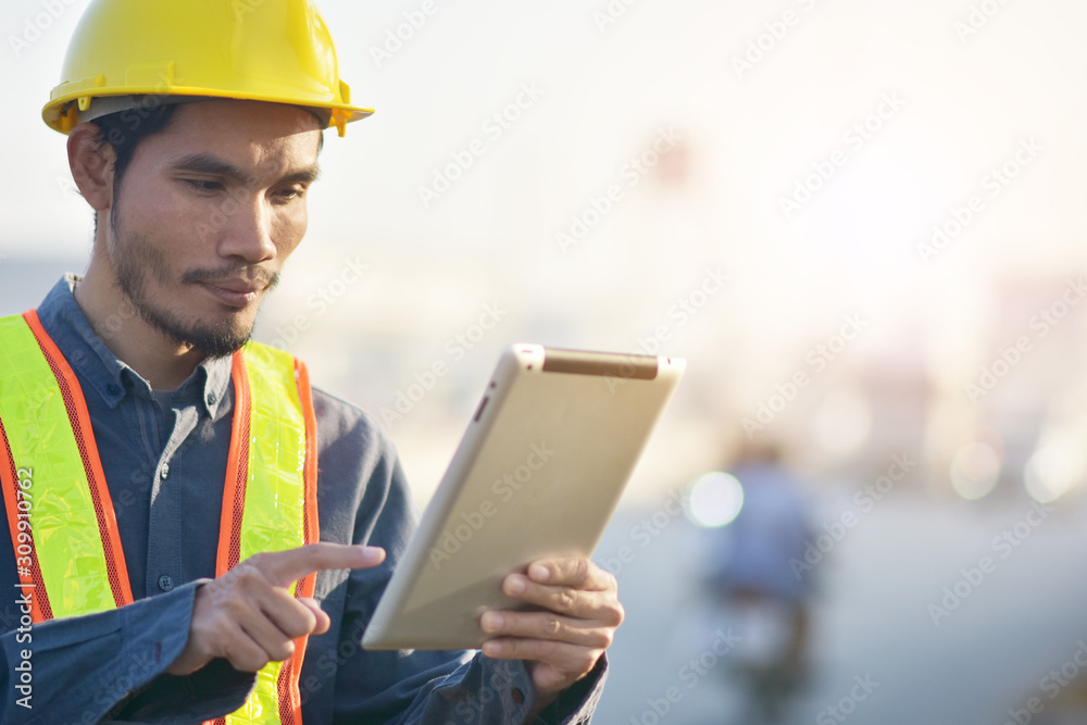 Engineering Holding tablet Highway transportation on road background,Engineer use tablet technology analysis data to planing work construction Engineering Holding tablet Highway transportation on road background,Engineer use tablet technology analysis data to planing work construction