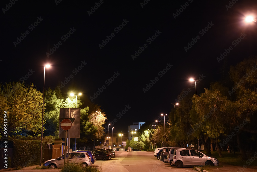 Night Illuminated City by Lamps With Parked Cars