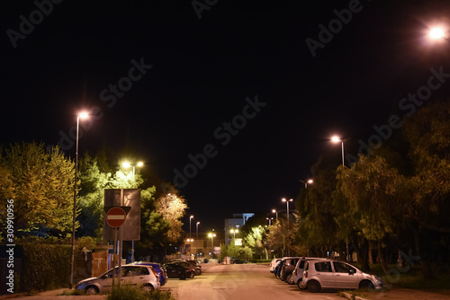 Night Illuminated City by Lamps With Parked Cars © FabriZiock