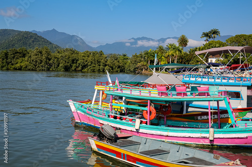 Wallpaper Mural View to colorful tour boats in the water waiting for tourists at a pier, with green mountains in the background, Paraty, Brazil, Unesco World Heritage Torontodigital.ca