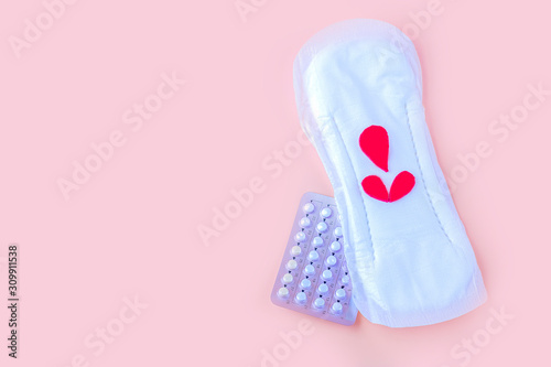 Protective menstrual pad and contraceptive pills. The concept of women gynecological health and intimate hygiene. Flat lay, copy space for text, close up photo