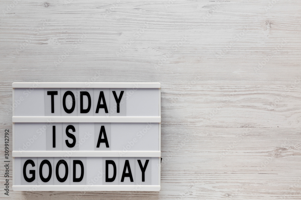 'Today is a good day' words on a lightbox on a white wooden background, top view. Overhead, from above, flat lay. Copy space. 'Today is a good day' words on a lightbox on a white wooden background, top view. Overhead, from above, flat lay. Copy space.
