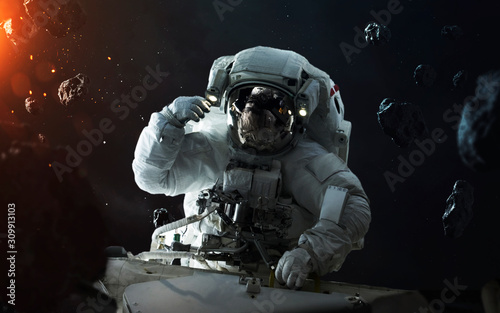 Fototapeta Naklejka Na Ścianę i Meble -  Astronaut at spacewalk in asteroid field. Elements of this image furnished by NASA