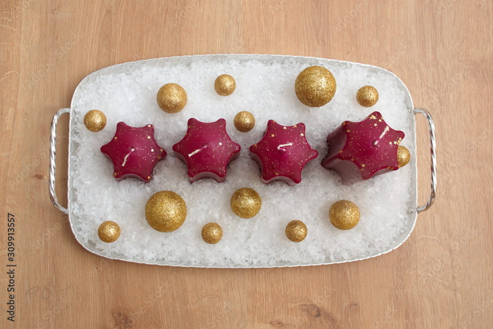 Directly above shot of Christmas candles with golden balls against the wooden background Directly above shot of Christmas candles with golden balls against the wooden background