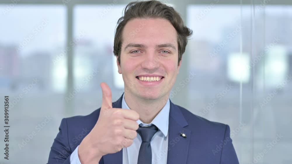Portrait of Cheerful Young Businessman showing Thumbs Up Portrait of Cheerful Young Businessman showing Thumbs Up