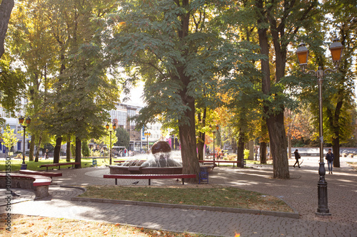 Fényképezés Autumn in Vinnytsia Central Park with Floating Sphere Fountain and Red Benches,