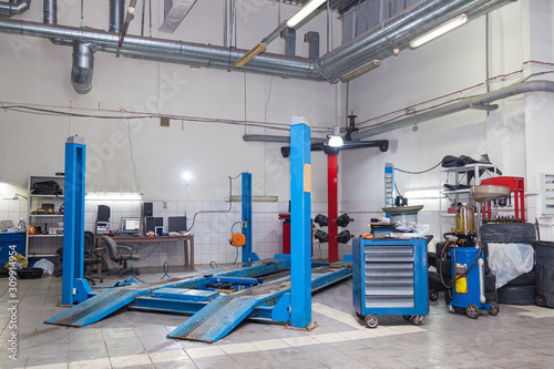 Blue stand wheel alignment convergence of the car during regular maintenance in the workshop for repair of vehicles . Auto service industry.