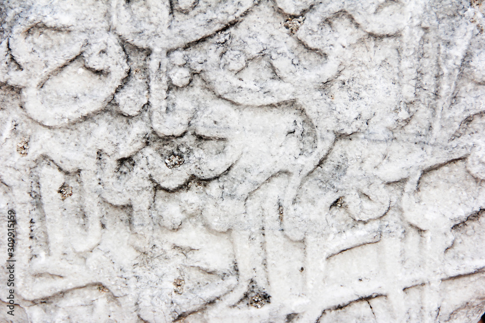 fragment of a gray stone wall depicting oriental patterns hieroglyphs fragment of a gray stone wall depicting oriental patterns hieroglyphs