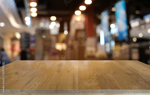 Empty dark wooden table in front of abstract blurred bokeh background of restaurant . can be used for display or montage your products.Mock up for space. © Charlie's