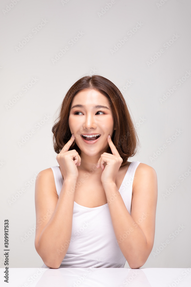 Beautiful Asian young woman touching soft cheek smile with clean and fresh skin Happiness and cheerful with positive emotional,isolated on gray background,Beauty and Cosmetics Concept Beautiful Asian young woman touching soft cheek smile with clean and fresh skin Happiness and cheerful with positive emotional,isolated on gray background,Beauty and Cosmetics Concept