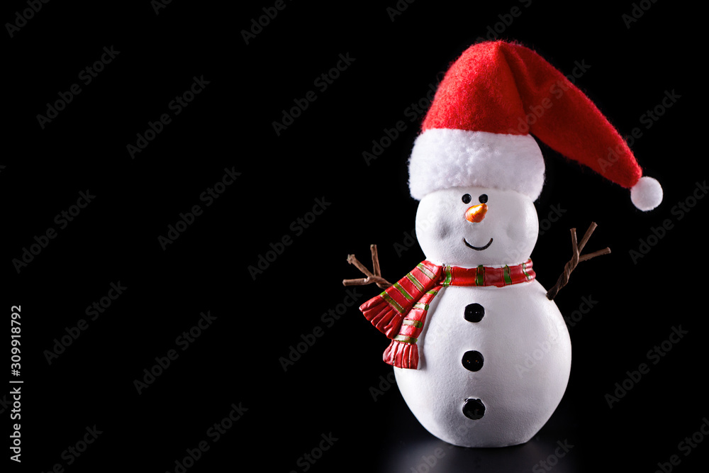 Snowman toy isolated on black background