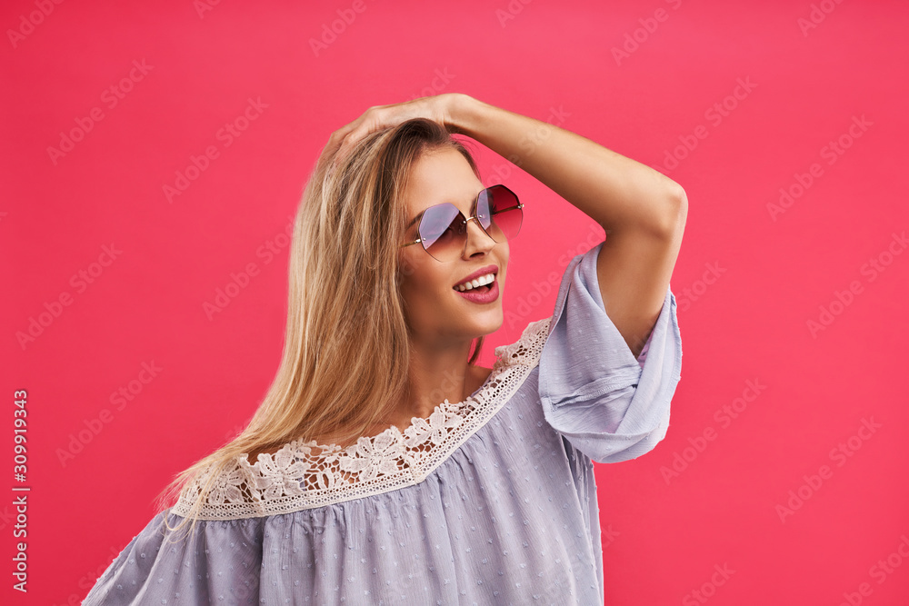 Beautiful adult woman posing over pink background