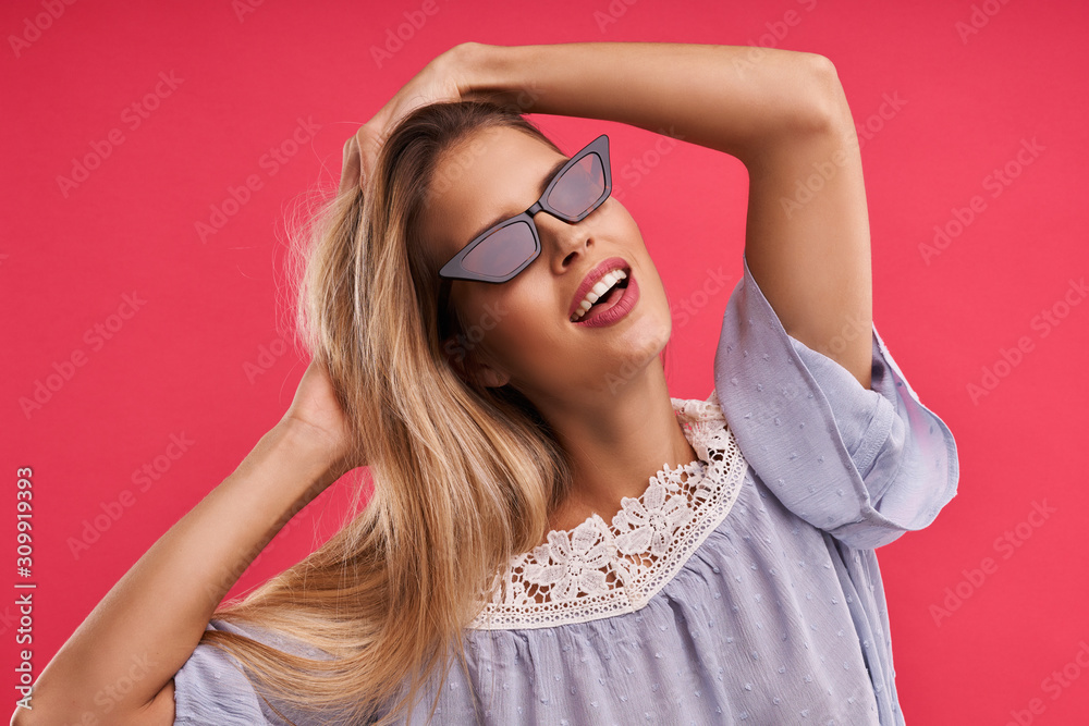 Beautiful adult woman posing over pink background Beautiful adult woman posing over pink background