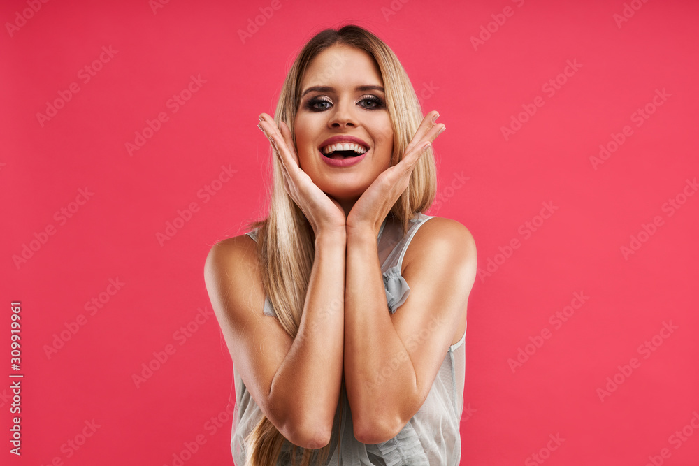 Beautiful adult woman posing over pink background Beautiful adult woman posing over pink background