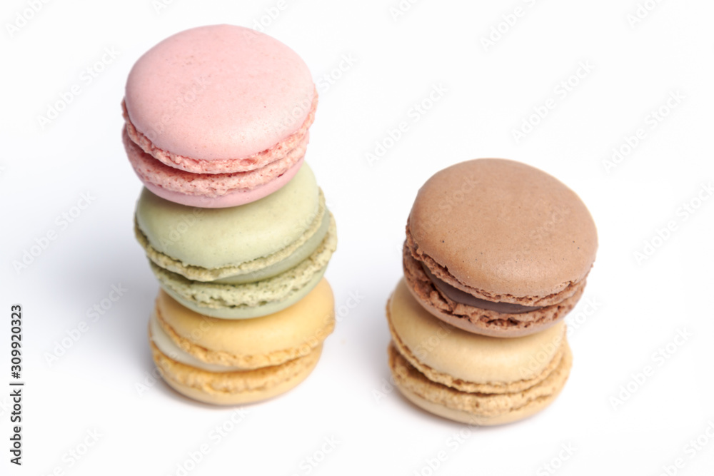 macaroons in several colors and tastes stacked on a white background macaroons in several colors and tastes stacked on a white background