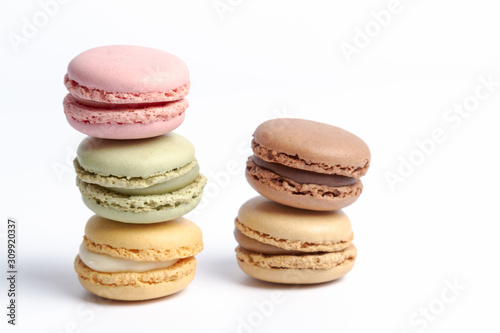 macaroons in several colors and tastes stacked on a white background