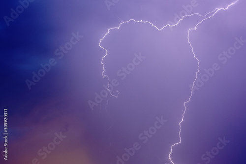 lightning in the night blue-lilac sky two long curving curves