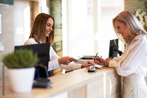 Tela Receptionist and businesswoman at hotel front desk
