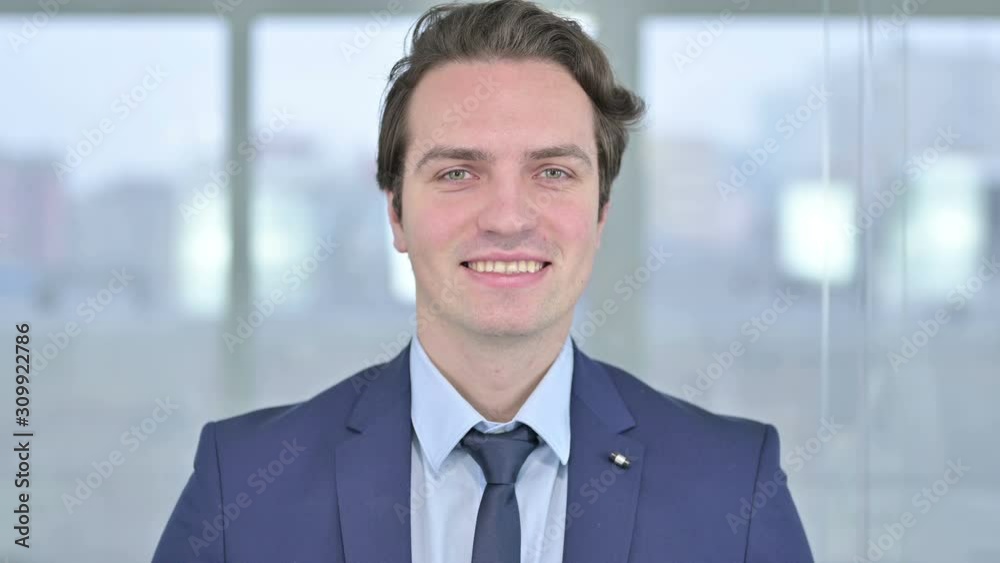 Portrait of Smiling Young Businessman Looking at the Camera Portrait of Smiling Young Businessman Looking at the Camera