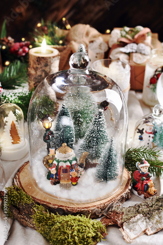 Christmas retro decoration with winter scene inside glass dome photo