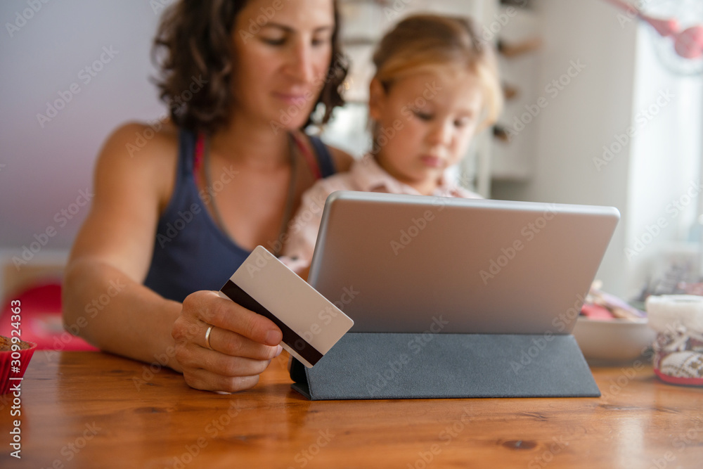 Mother paying with credit card from home Mother paying with credit card from home