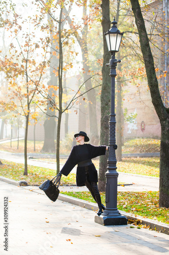 stylish woman in autumn park