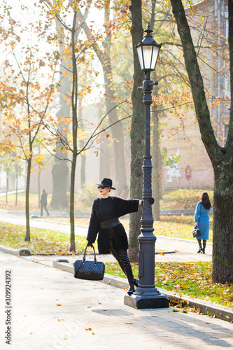 stylish woman in autumn park