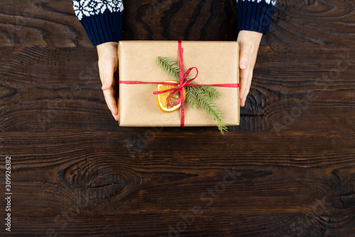 Craft gift in childres hands on wooden background photo