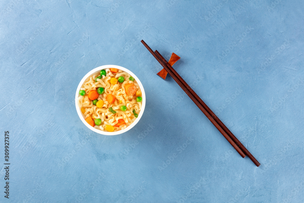 Ramen cup, instant soba noodles in a plastic cup, shot from the top with chopsticks and copy space, a flat lay Ramen cup, instant soba noodles in a plastic cup, shot from the top with chopsticks and copy space, a flat lay