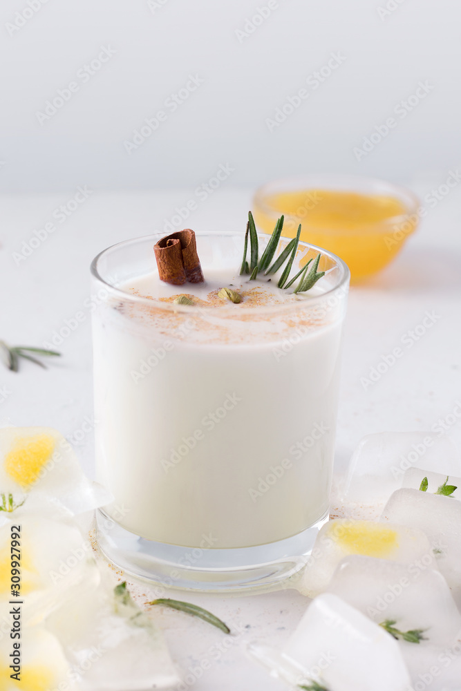 Lassi Indian drink next to orange jam on a white background. There is a place for text Lassi Indian drink next to orange jam on a white background. There is a place for text