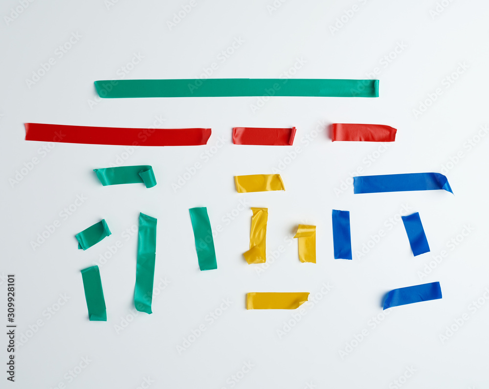 Fototapeta premium set of torn multicolored rubber pieces of electrical tape glued to a white background