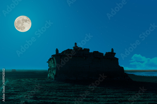 A romantic full moon night in Spain. A traditional pigeon house built of stone in the Spanish region of Castilla y Leon in the north of the country. A nesting place for pigeons.