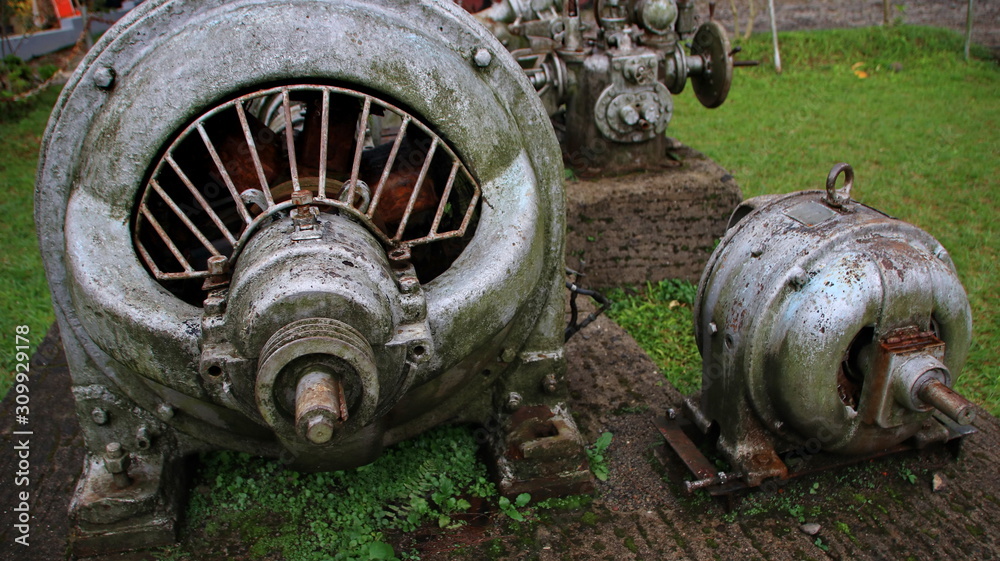 A statue of a tea leaf processing machine monument in a park on a mountain A statue of a tea leaf processing machine monument in a park on a mountain