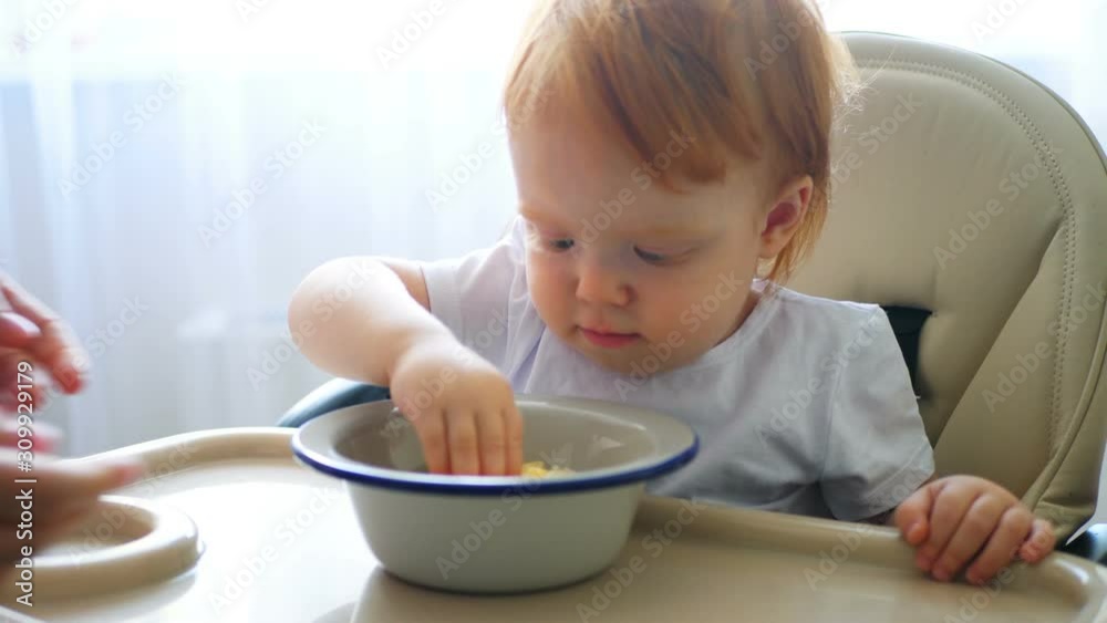 Child eating carrot and other vegetables by himself, self-feeding. Child eating carrot and other vegetables by himself, self-feeding.
