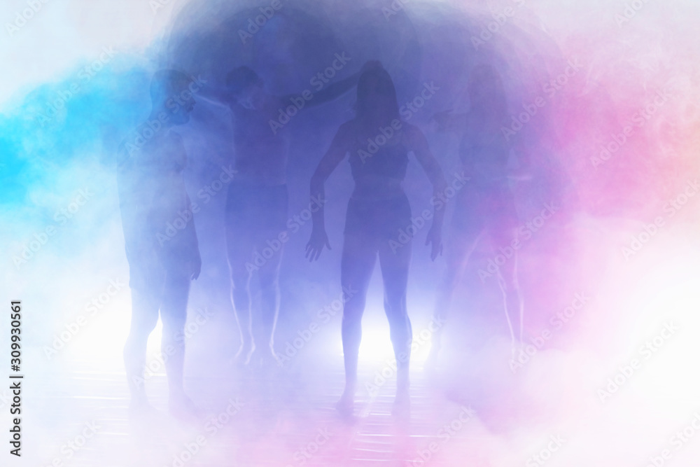 Obraz premium Group of modern male and female street dancers performing different moves in the studio. Effective performance. Beautiful dance.