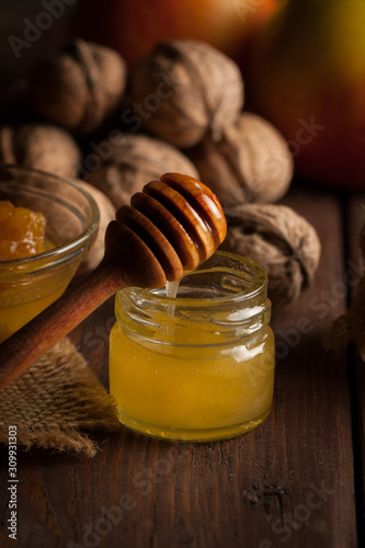 honey dipper and honeycomb. nuts and apples with honey and nuts of various kinds