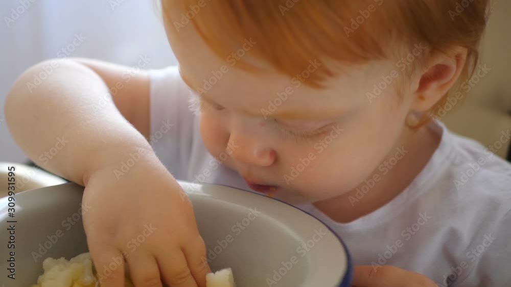 Child eating carrot and other vegetables by himself, self-feeding. Child eating carrot and other vegetables by himself, self-feeding.