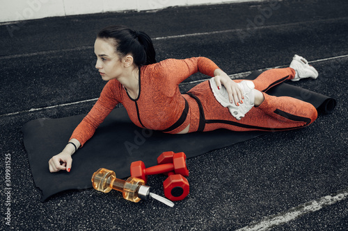 Portrait of One Sports Fitness Girl Dressed Fashion Sportswear Outfit Doing Stretches Exercise and Training at the City Stadium, Healthy Lifestyle Concept