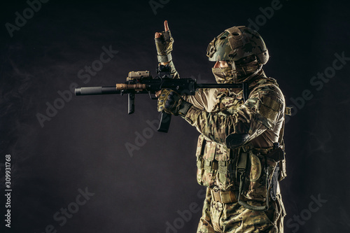 Canvas Print side view on soldier counting, expect shooting from weapon rifle gun isolated ov