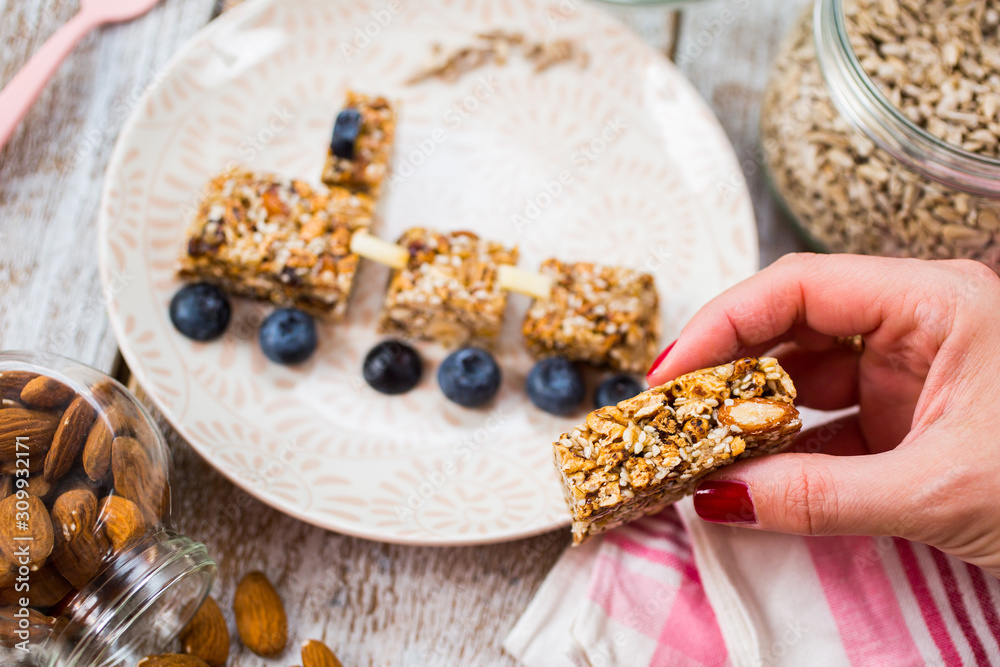 Fototapeta premium Fun food for kids. Homemade healthy cookies made with sunflower seeds, sesame seeds, dry fruits and honey with berries