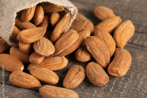 Almonds on wooden background. Healthy food concept.