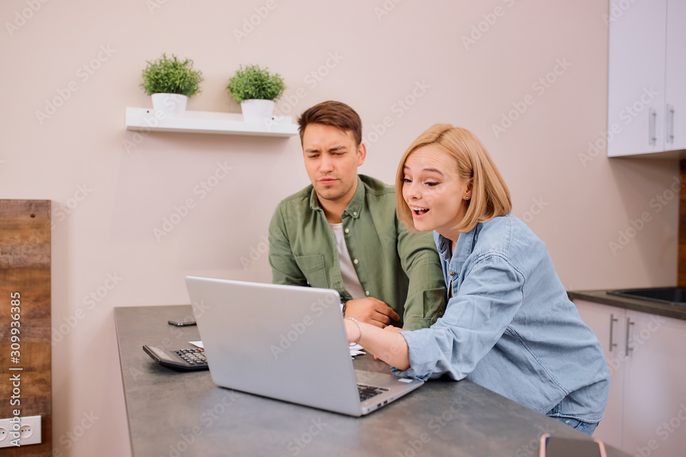 happy excited married couple use laptop and documents, discuss mortgage, analyzing together, happy relationship between wife and husband happy excited married couple use laptop and documents, discuss mortgage, analyzing together, happy relationship between wife and husband