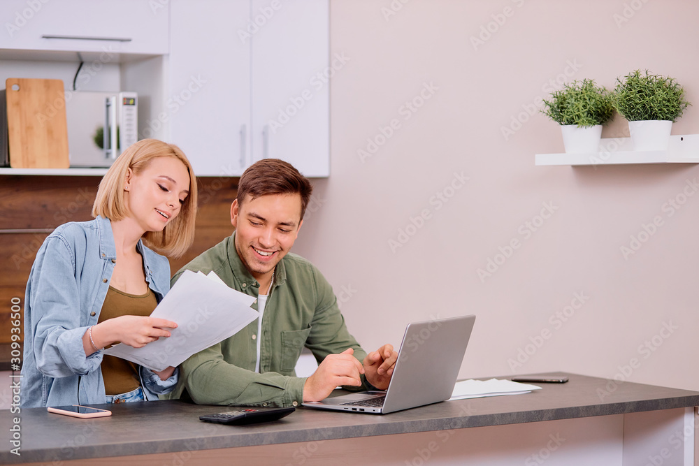 couple reading legal documents at home using modern laptop, family considering a mortgage or insurance, studying contract details, discussing conditions and looking at screen of laptop couple reading legal documents at home using modern laptop, family considering a mortgage or insurance, studying contract details, discussing conditions and looking at screen of laptop