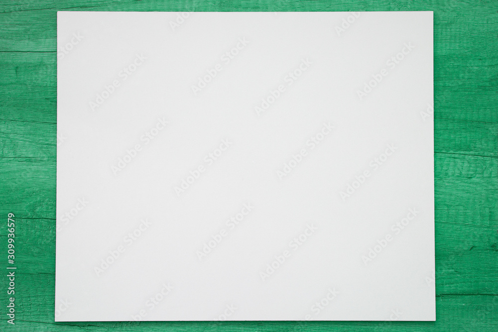 White mock up on a wooden background painted in green mint color