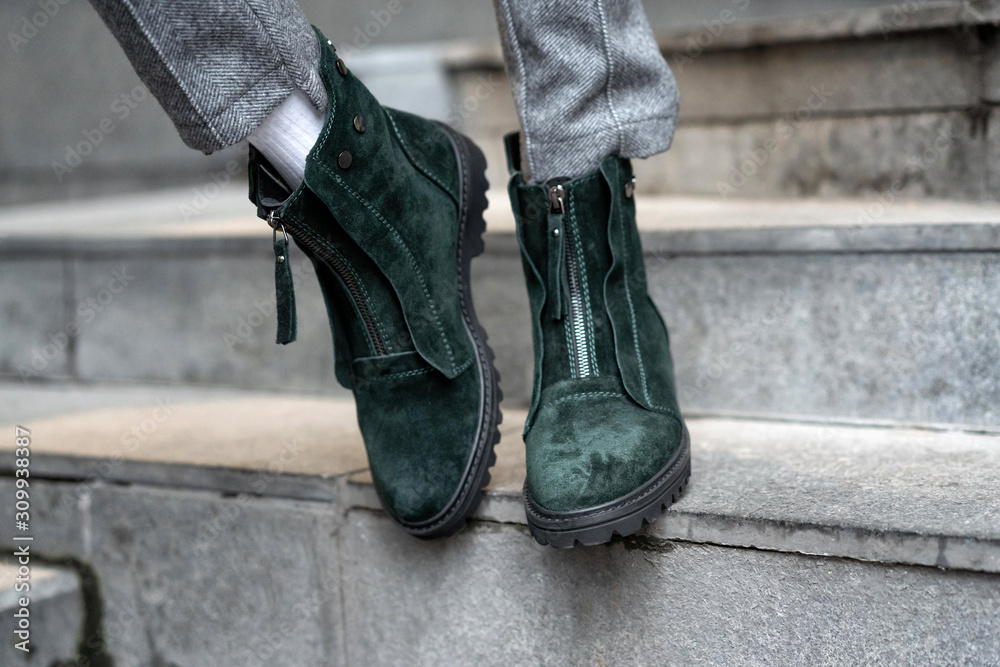 Close-up green womens shoes from nubuck demi season flat-toed on feet in the street in real conditions Close-up green womens shoes from nubuck demi season flat-toed on feet in the street in real conditions