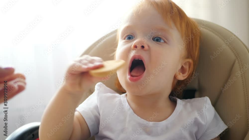 Child eating cookie and drinking juice Child eating cookie and drinking juice