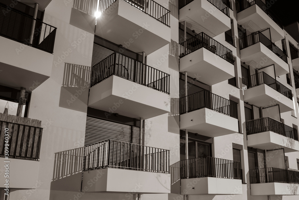 House facade with many balconies at night, many balconies at night, black and white photo House facade with many balconies at night, many balconies at night, black and white photo